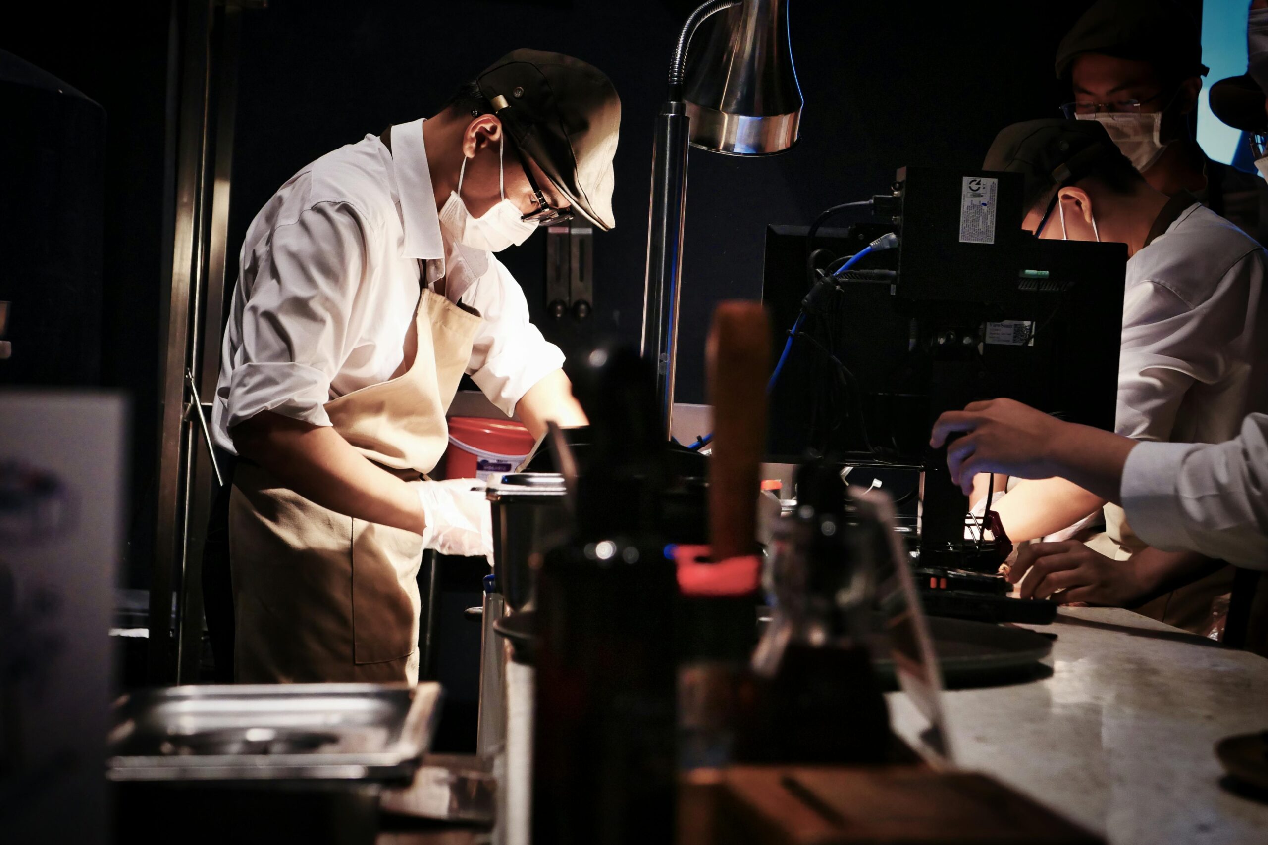 Chefs in a busy restaurant kitchen preparing dishes with precision and teamwork.